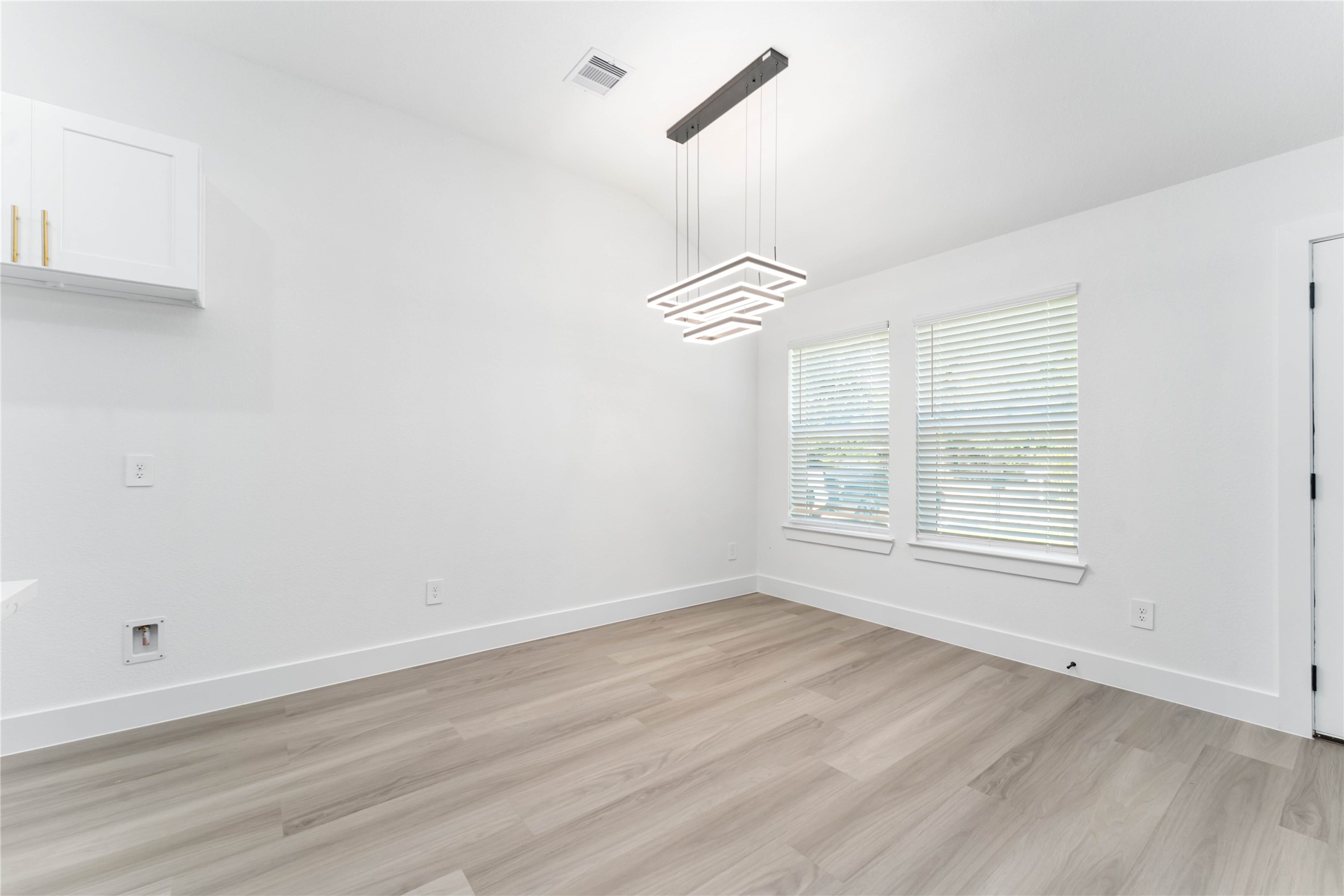 9406 Sandra Street, Unit A Houston, TX 77016 - Photo 11 of 28 a view of an empty room with a window and wooden floor