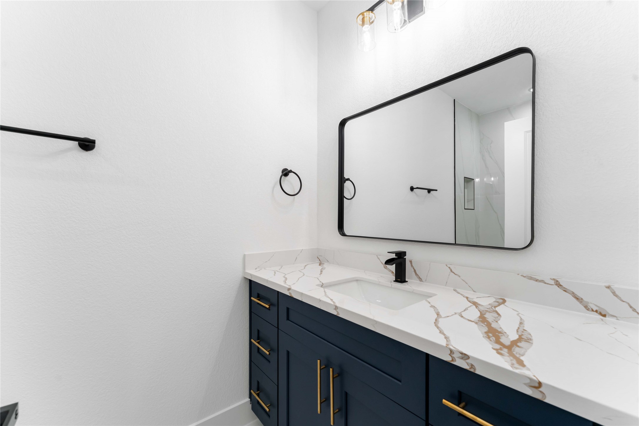 9406 Sandra Street, Unit A Houston, TX 77016 - Photo 14 of 28 a bathroom with a sink and mirror