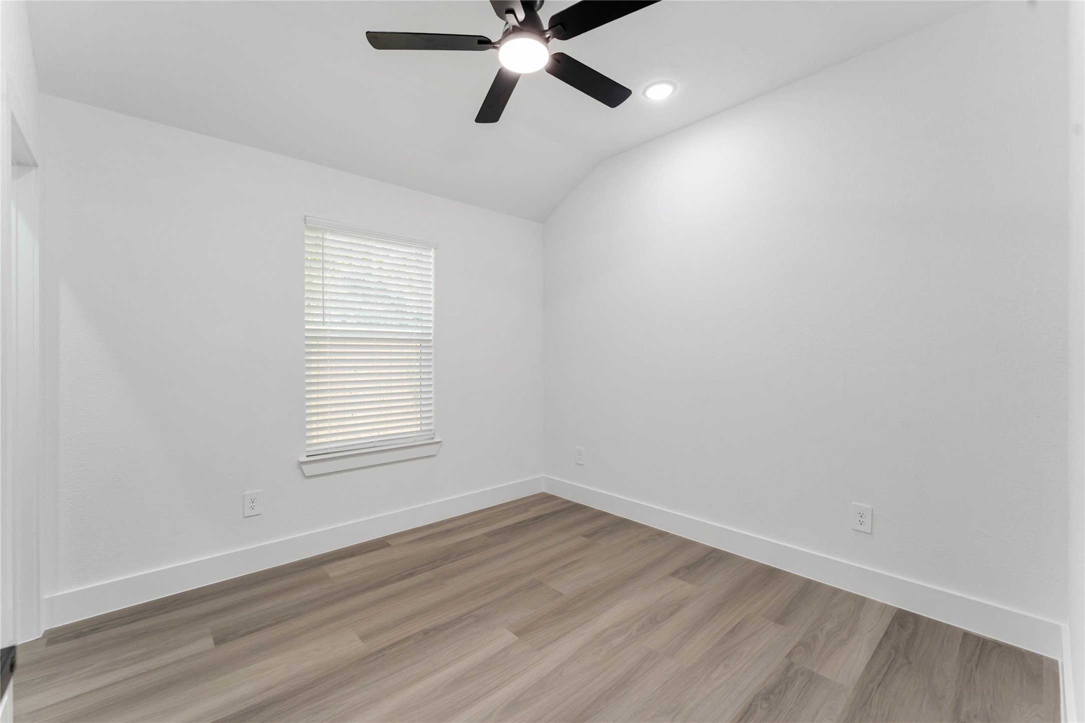 9406 Sandra Street, Unit A Houston, TX 77016 - Photo 19 of 28 wooden floor in an empty room with a window
