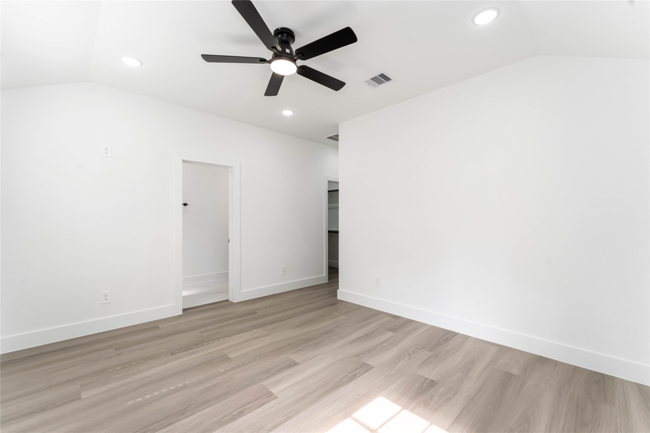 9406 Sandra Street, Unit A Houston, TX 77016 - Photo 22 of 28 an empty room with wooden floor and a ceiling fan