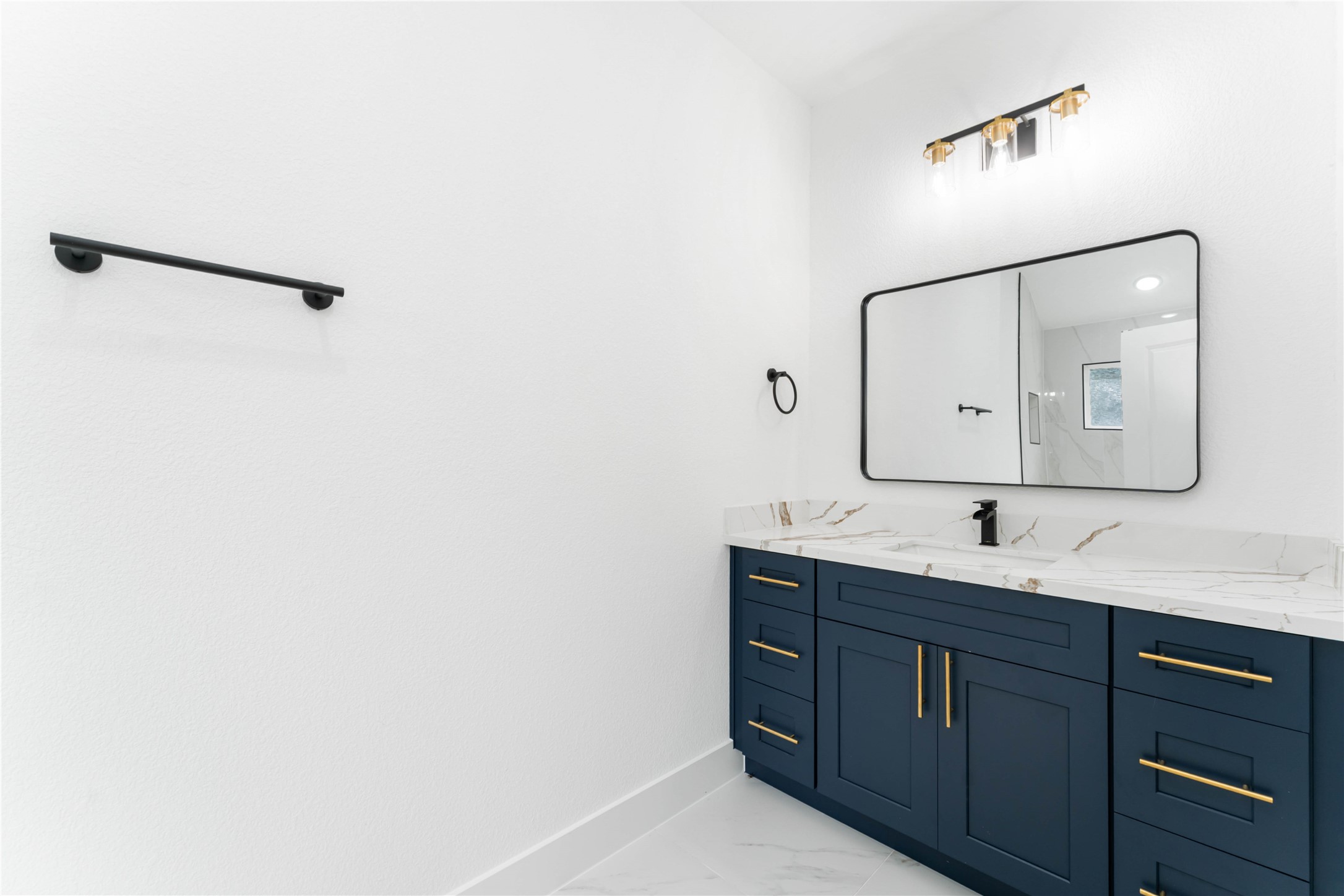 9406 Sandra Street, Unit A Houston, TX 77016 - Photo 23 of 28 a bathroom with a double vanity sink and mirror