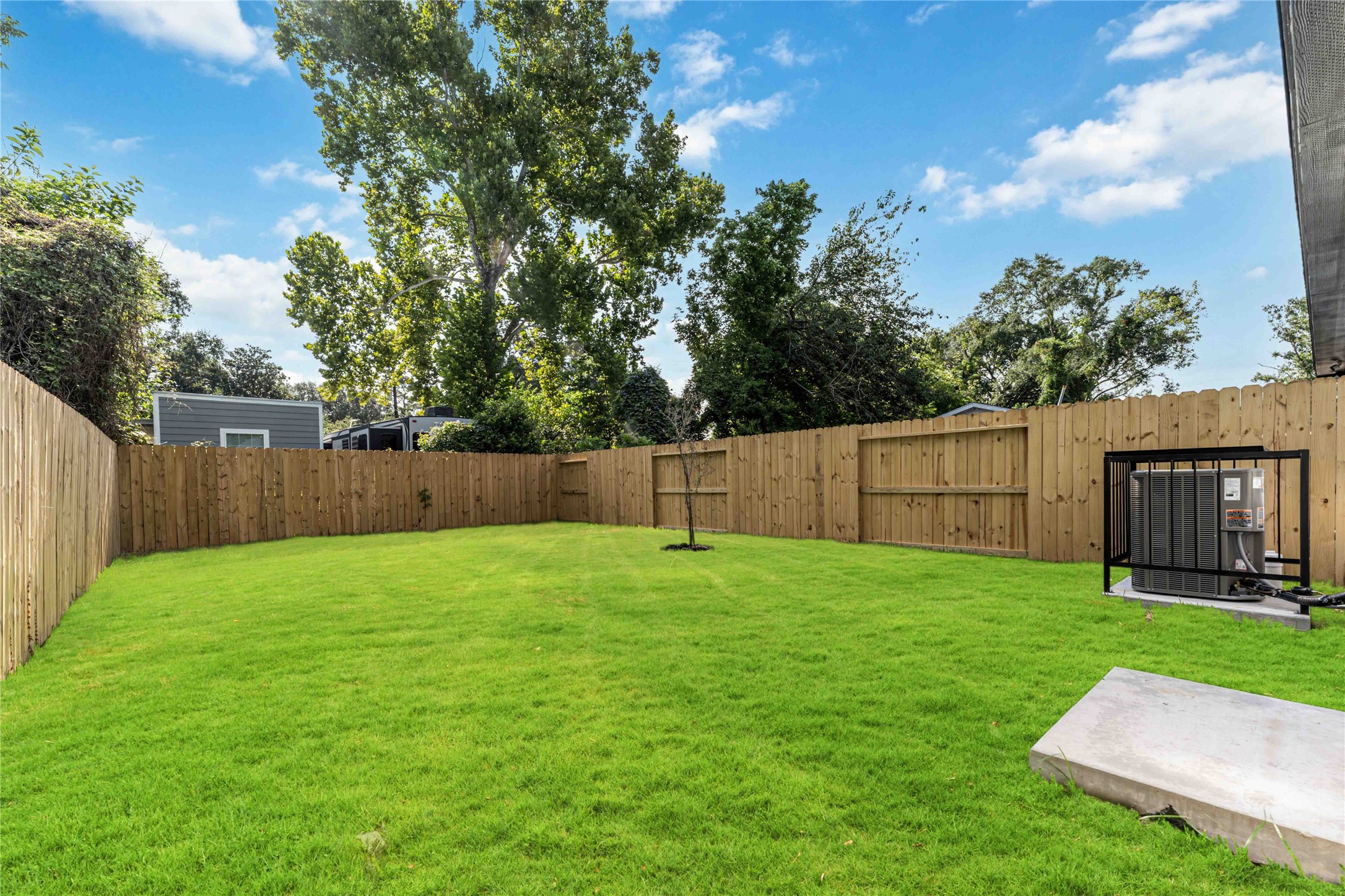 9406 Sandra Street, Unit A Houston, TX 77016 - Photo 27 of 28 a view of a backyard with a garden and wooden fence