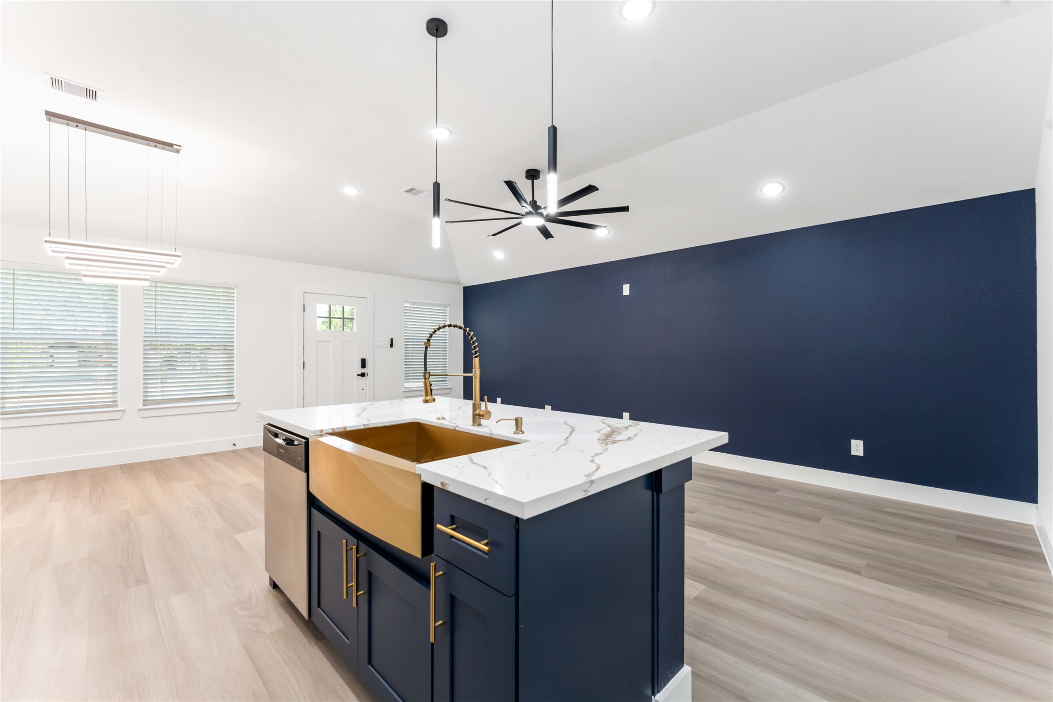9406 Sandra Street, Unit A Houston, TX 77016 - Photo 7 of 28 a kitchen with a sink a stove and wooden floor