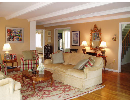 12 Links Road Gloucester, MA 01930 - Photo 3 of 10 a living room with couches and a dining table with wooden floor