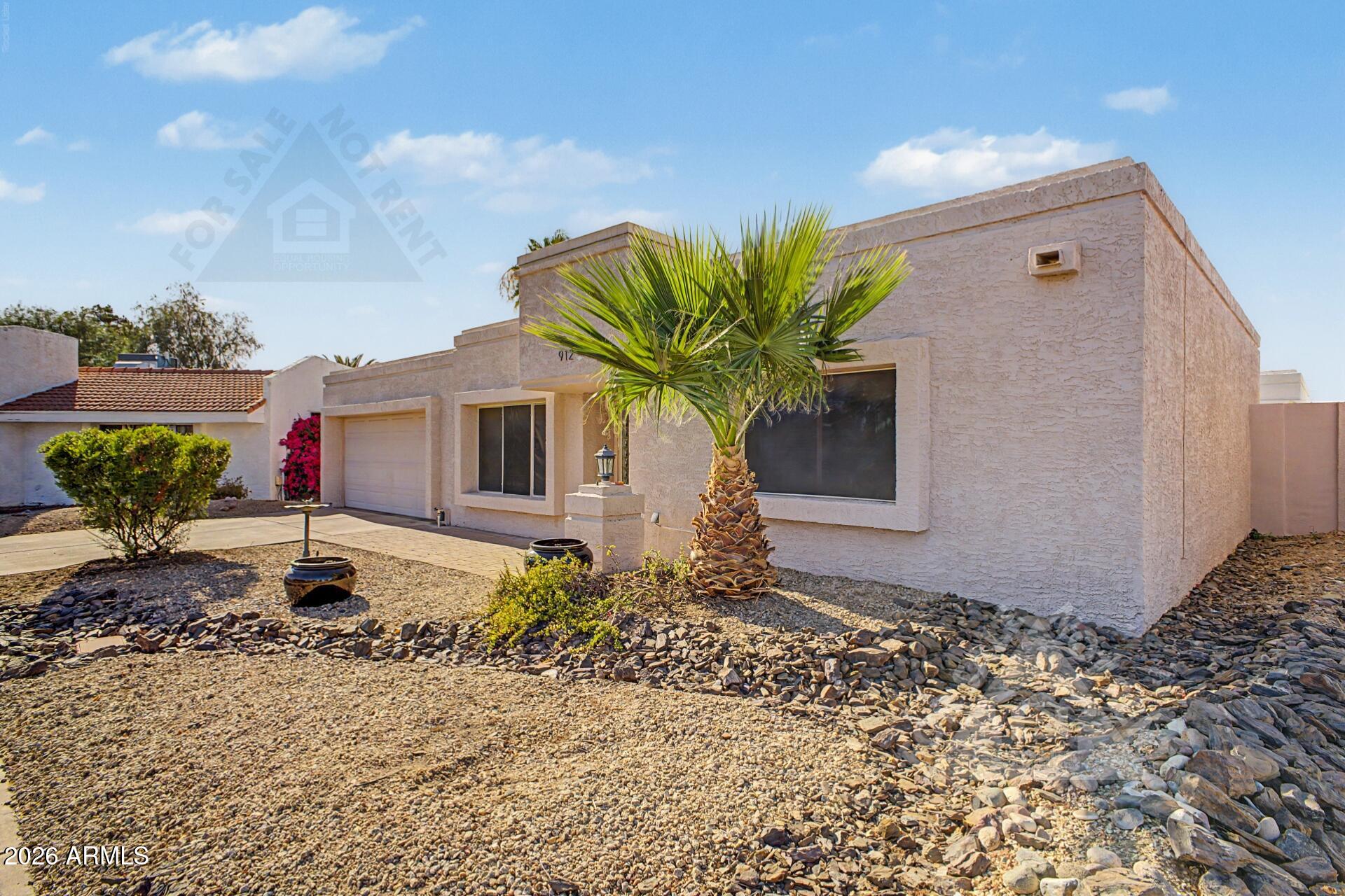 912 East Villa Rita Drive Phoenix, AZ 85022 - Photo 24 of 27 a front view of a house with garden
