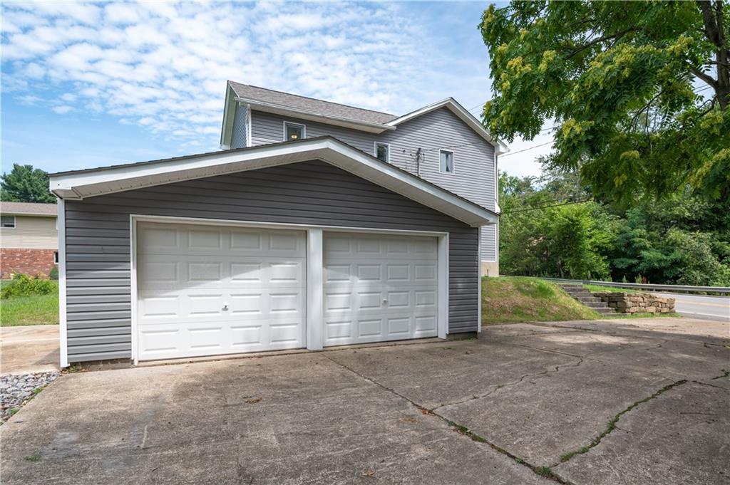 147 Highway 68 Rochester, PA 15074 - Photo 3 of 25 a front view of a house with a yard and garage