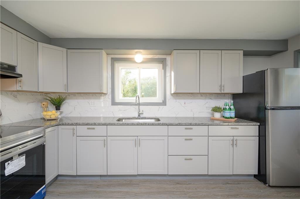 147 Highway 68 Rochester, PA 15074 - Photo 7 of 25 a kitchen with a sink a window and cabinets
