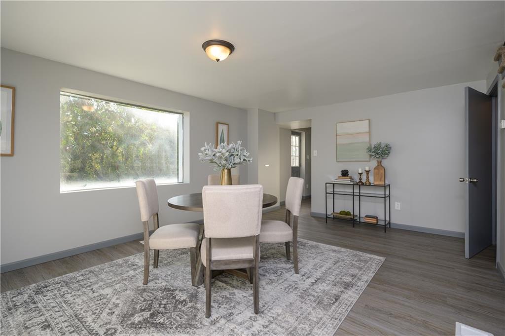 147 Highway 68 Rochester, PA 15074 - Photo 8 of 25 a dining room with furniture a rug and wooden floor
