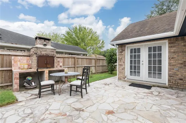 a view of a house with backyard porch and sitting area