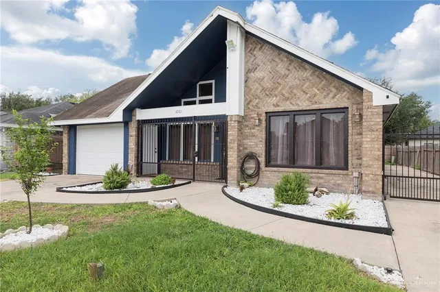 a front view of a house with garden and porch