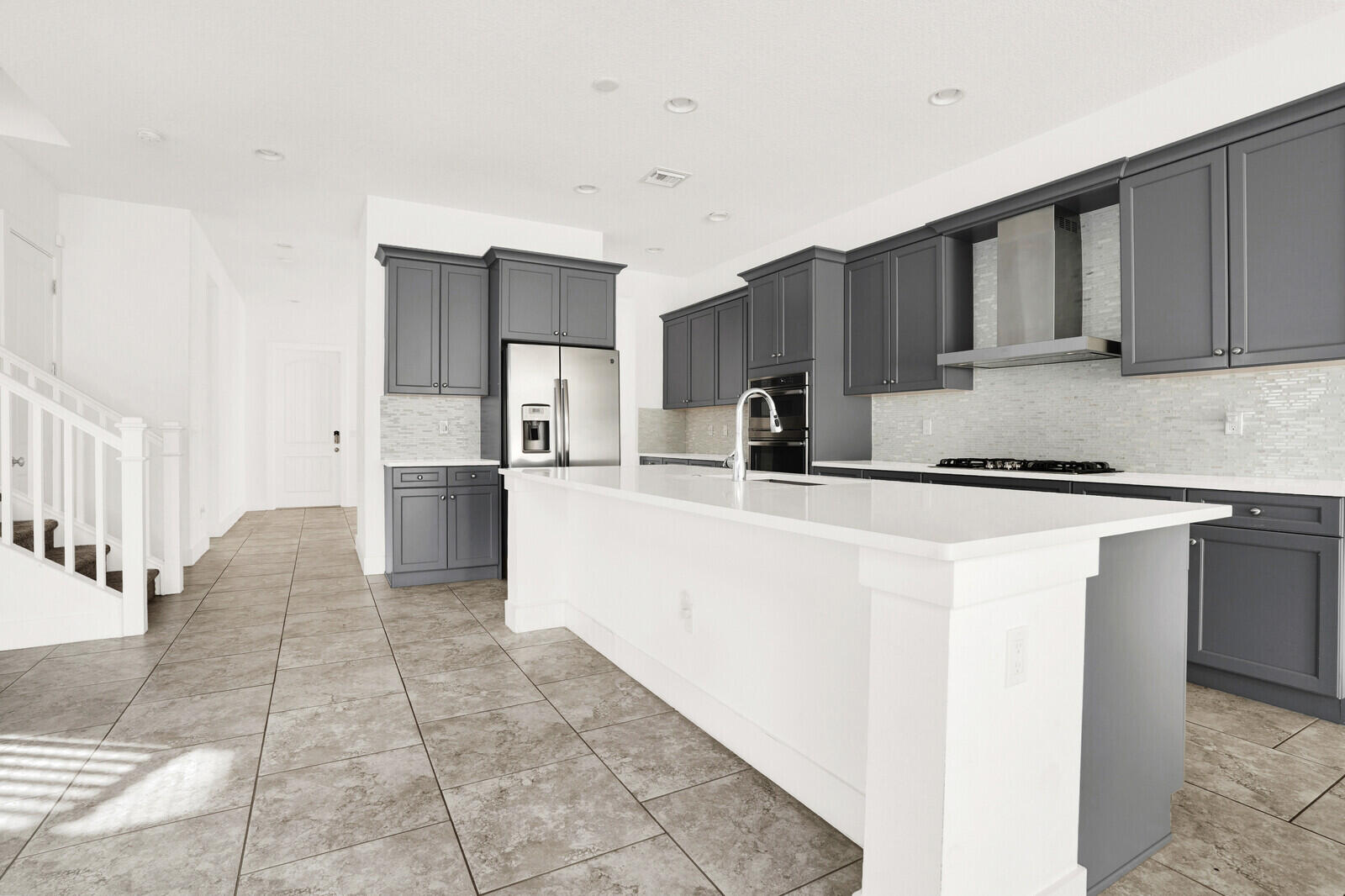 13628 Dumont Road Palm Beach Gardens, FL 33418 - Photo 11 of 44 a kitchen with stainless steel appliances a refrigerator sink and cabinets