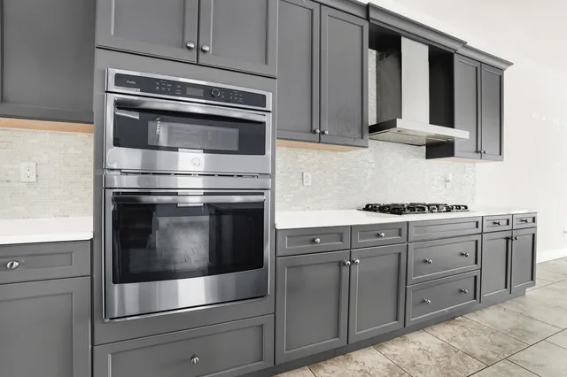 a kitchen with granite countertop white cabinets stainless steel appliances and sink