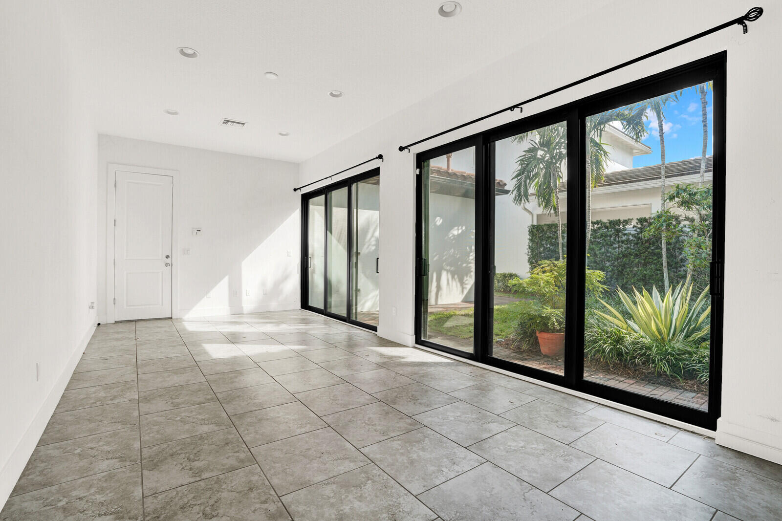 13628 Dumont Road Palm Beach Gardens, FL 33418 - Photo 21 of 44 a view of an empty room with windows