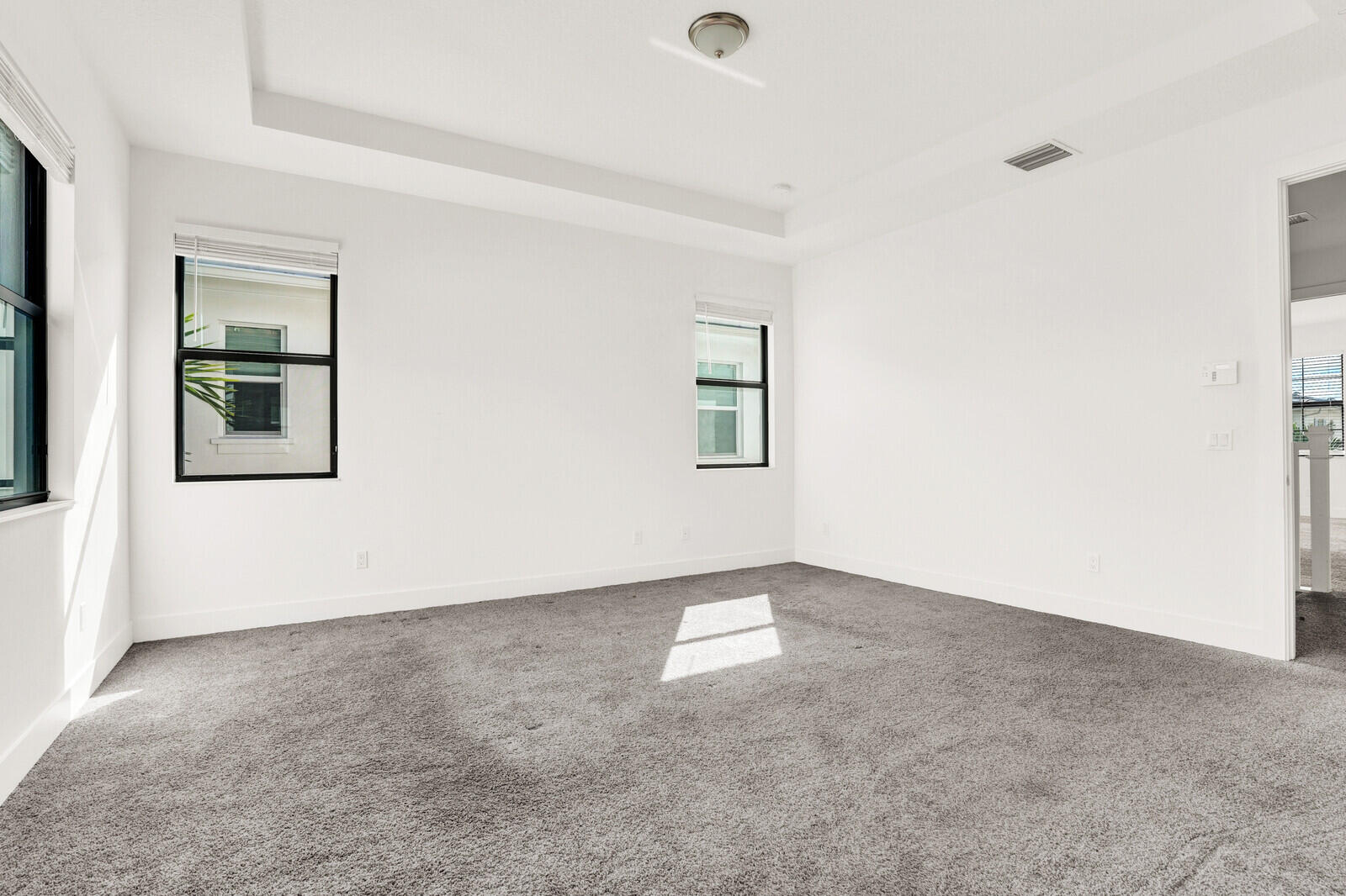 13628 Dumont Road Palm Beach Gardens, FL 33418 - Photo 25 of 44 an empty room with windows