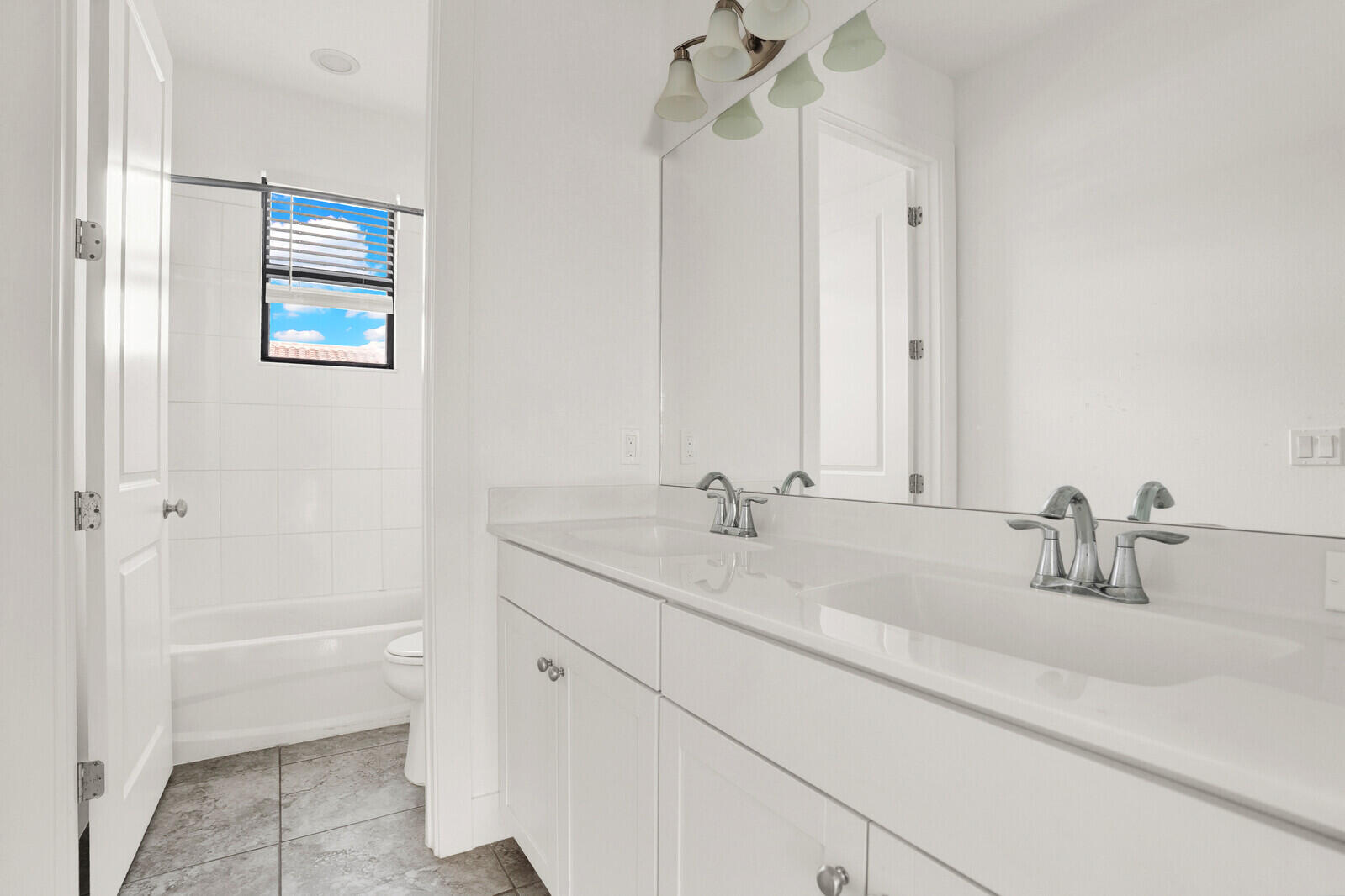 13628 Dumont Road Palm Beach Gardens, FL 33418 - Photo 32 of 44 a bathroom with a sink and a mirror