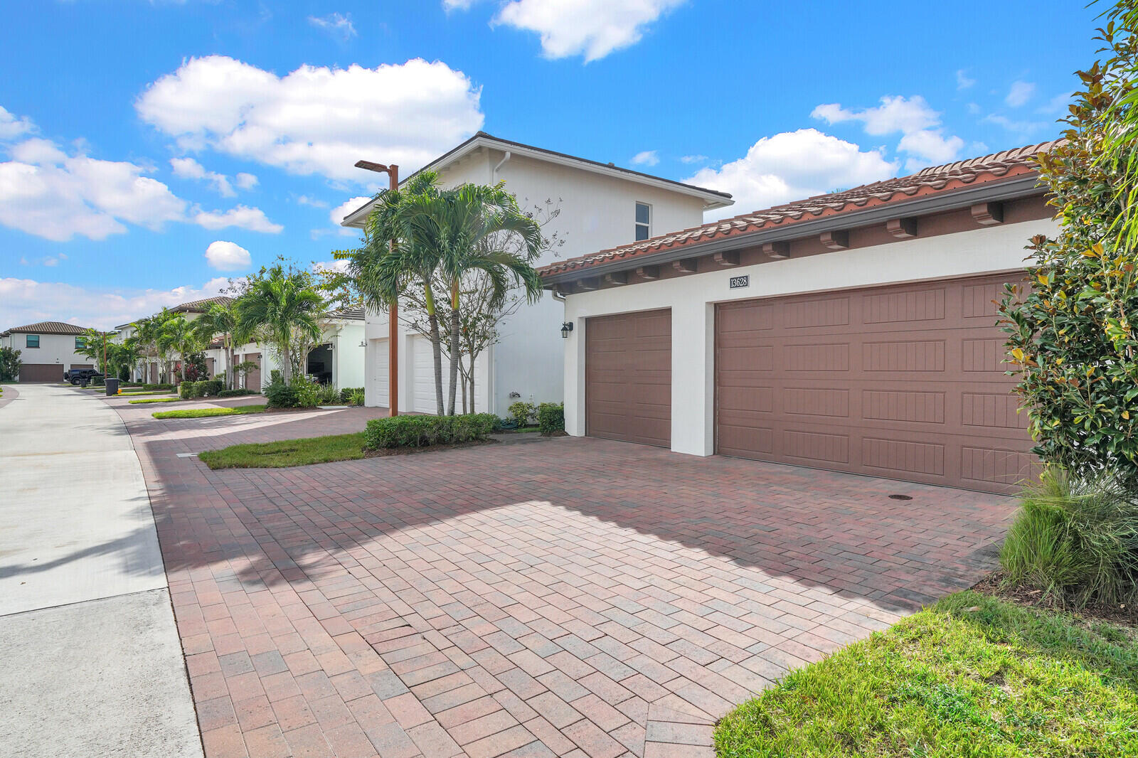 13628 Dumont Road Palm Beach Gardens, FL 33418 - Photo 38 of 44 a house with a yard and a garage