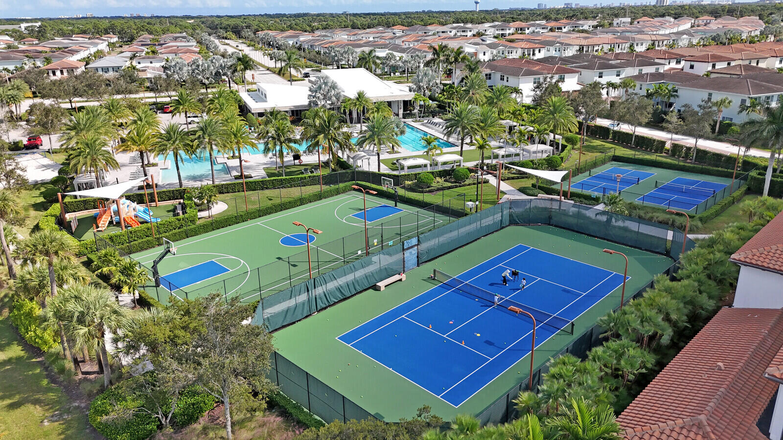13628 Dumont Road Palm Beach Gardens, FL 33418 - Photo 44 of 44 an aerial view of a tennis ground and a cars park side of the road