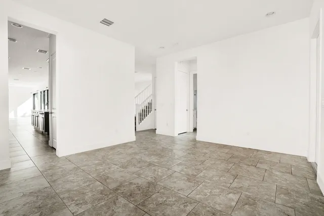 an empty room with an entrance to other room