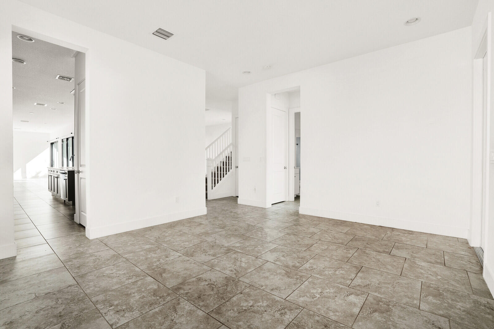 13628 Dumont Road Palm Beach Gardens, FL 33418 - Photo 5 of 44 an empty room with an entrance to other room