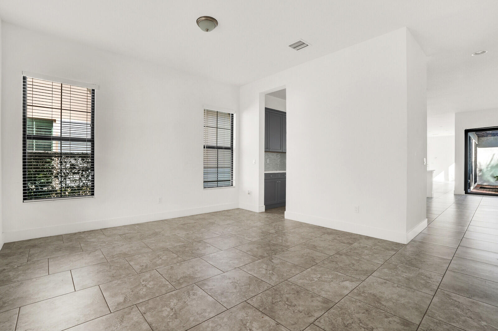 13628 Dumont Road Palm Beach Gardens, FL 33418 - Photo 6 of 44 a view of an empty room with a window