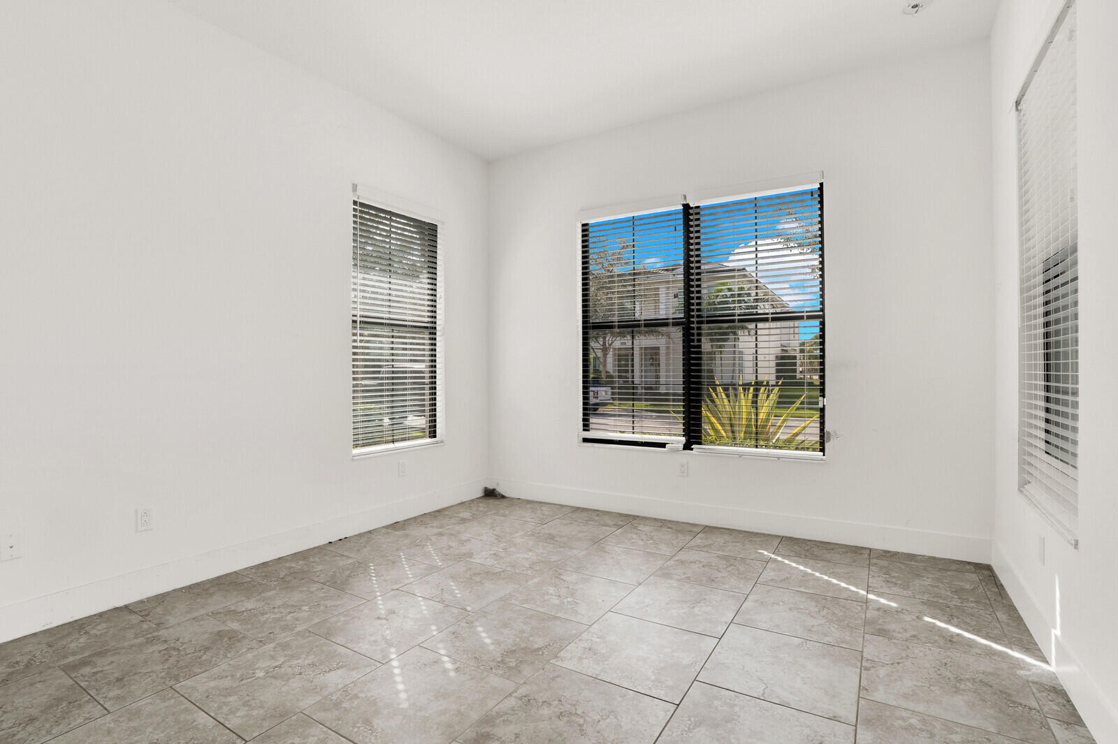 13628 Dumont Road Palm Beach Gardens, FL 33418 - Photo 7 of 44 an empty room with windows