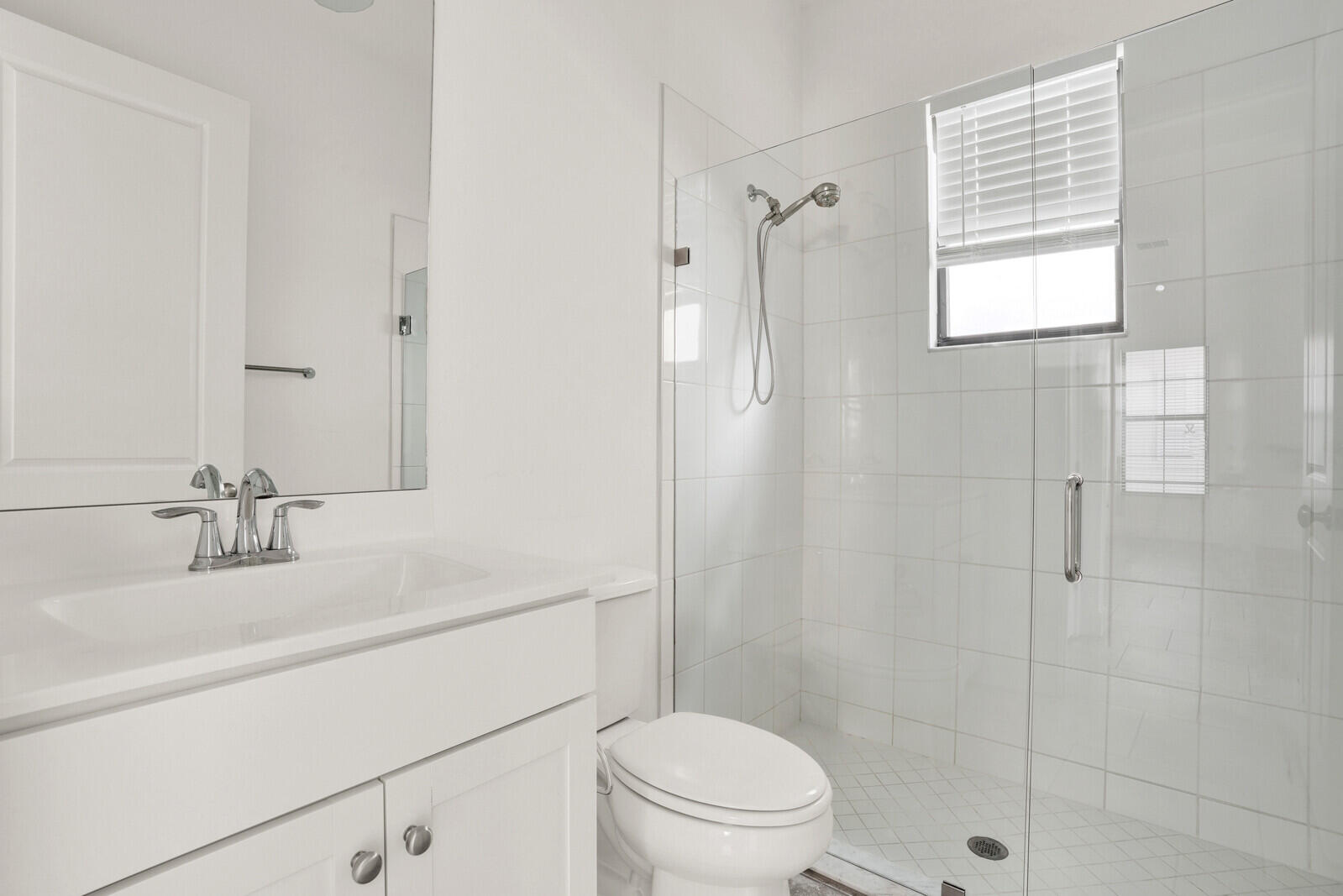 13628 Dumont Road Palm Beach Gardens, FL 33418 - Photo 8 of 44 a bathroom with a sink toilet vanity and shower