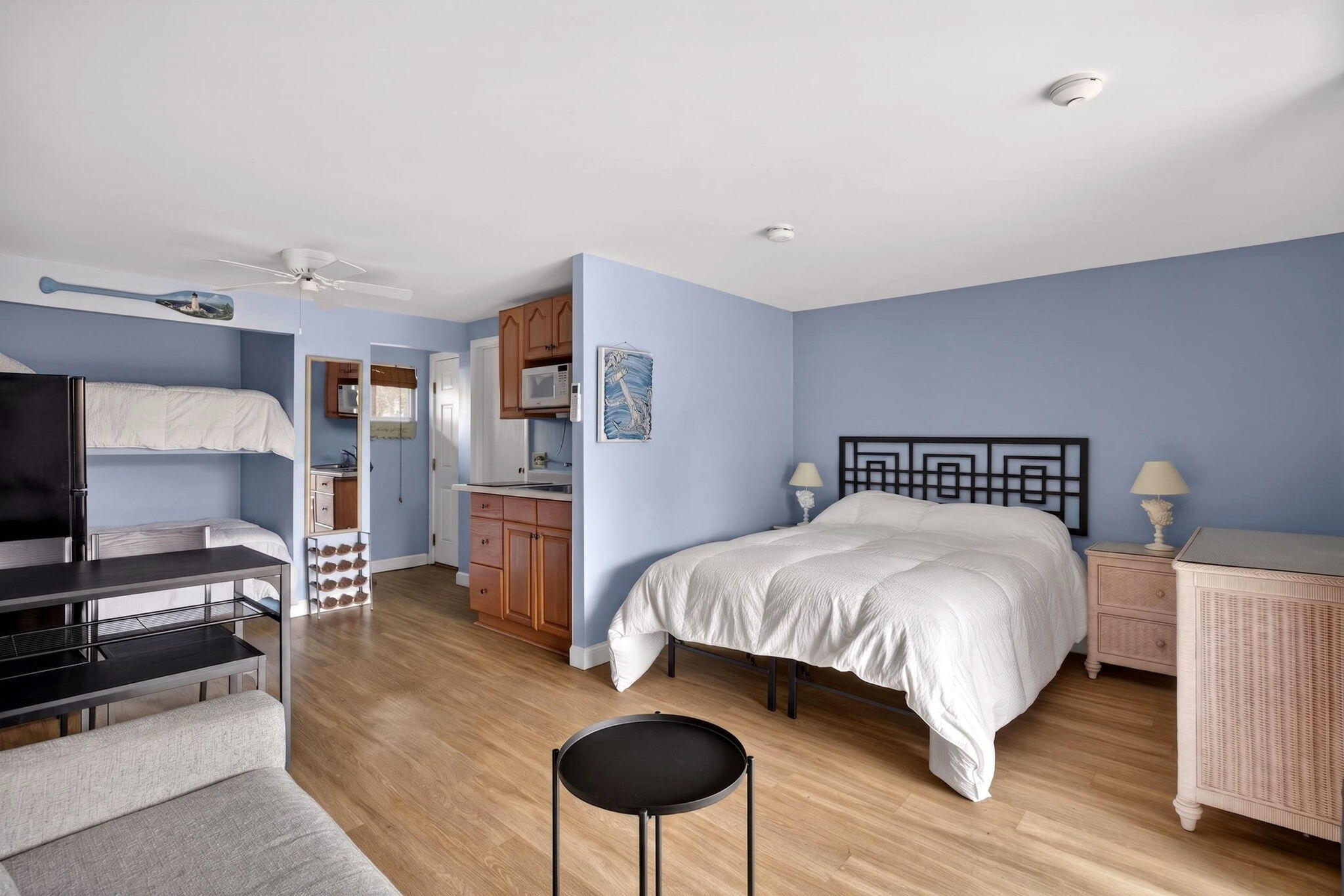 a bedroom with a large bed and a chandelier
