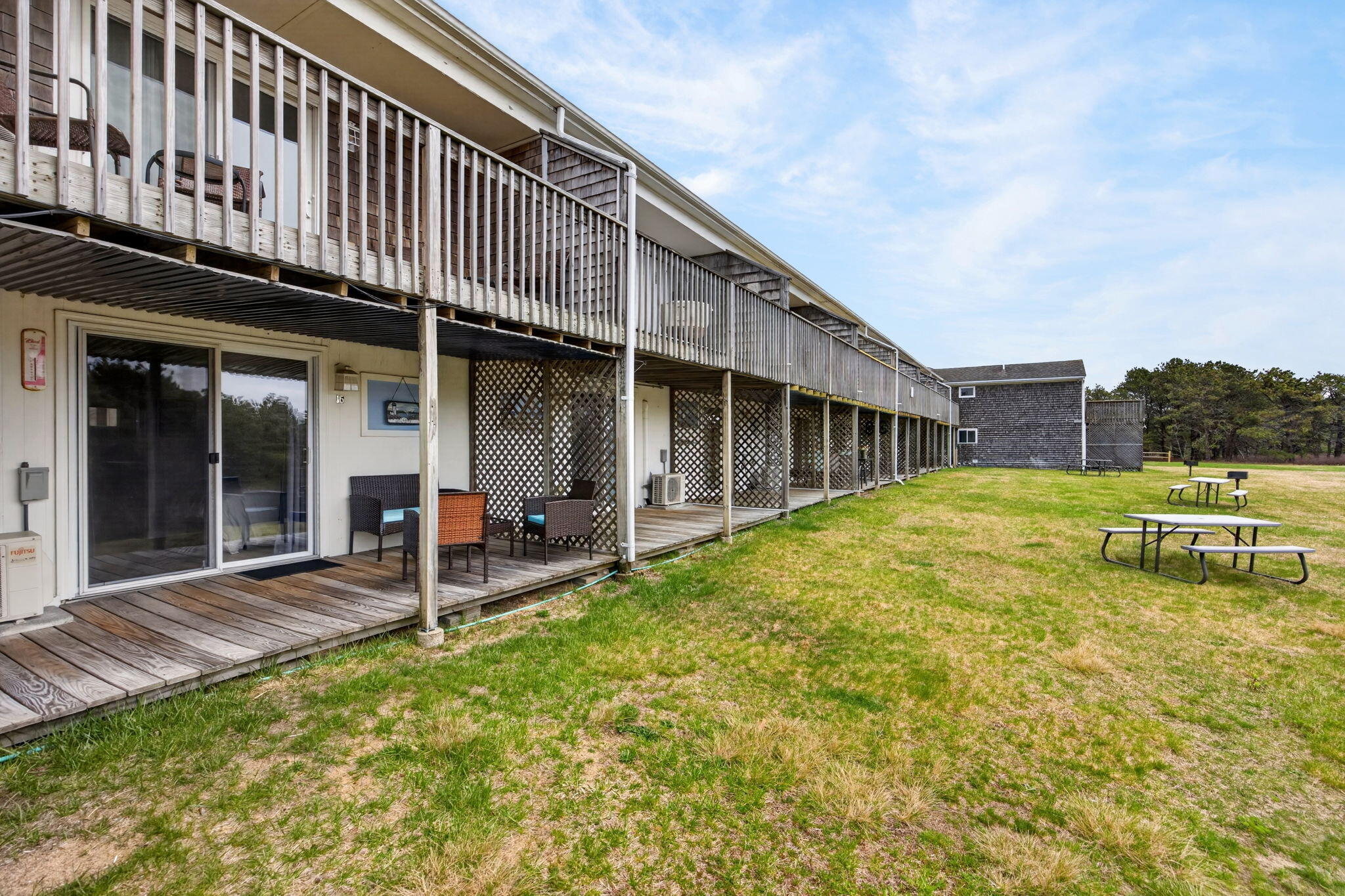 132 Shore Road, Unit 15 Truro, MA 02666 - Photo 23 of 33 a view of a house with a backyard porch and sitting area