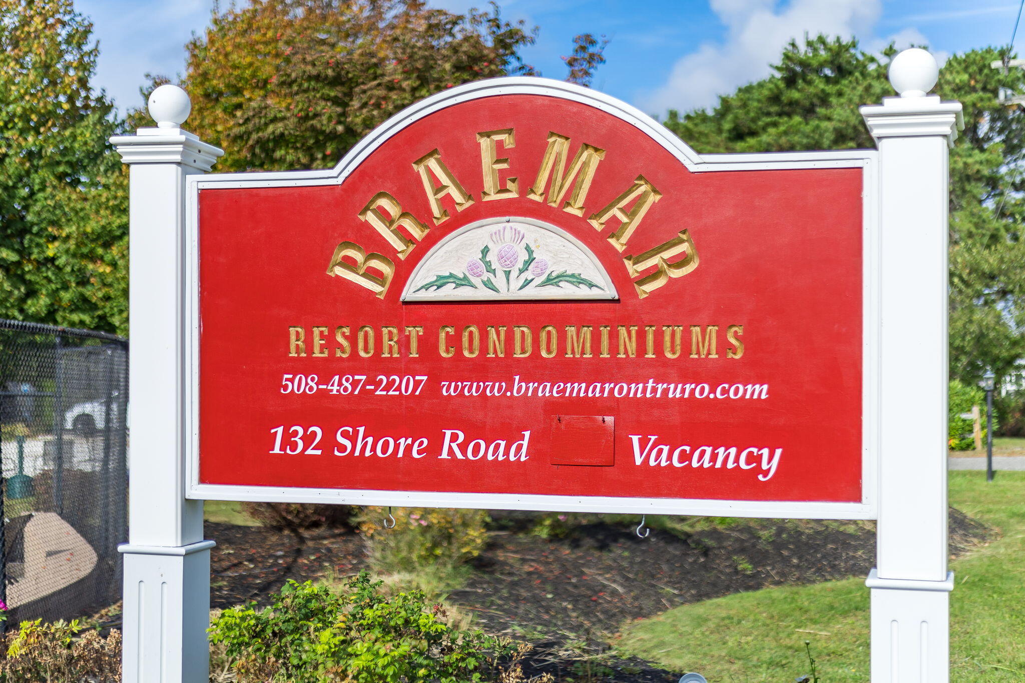 132 Shore Road, Unit 15 Truro, MA 02666 - Photo 32 of 33 a sign that is on a wooden bench