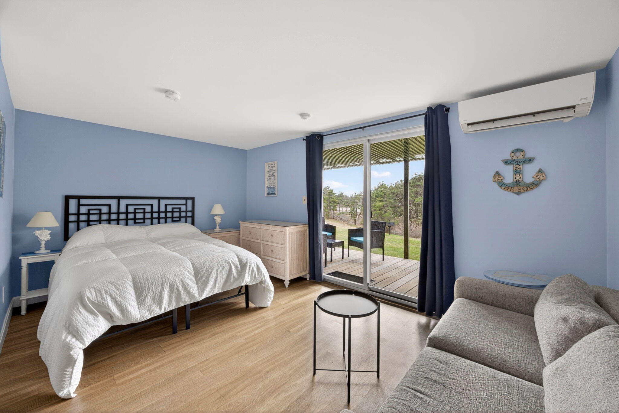 132 Shore Road, Unit 15 Truro, MA 02666 - Photo 4 of 33 a bedroom with a bed and glass window