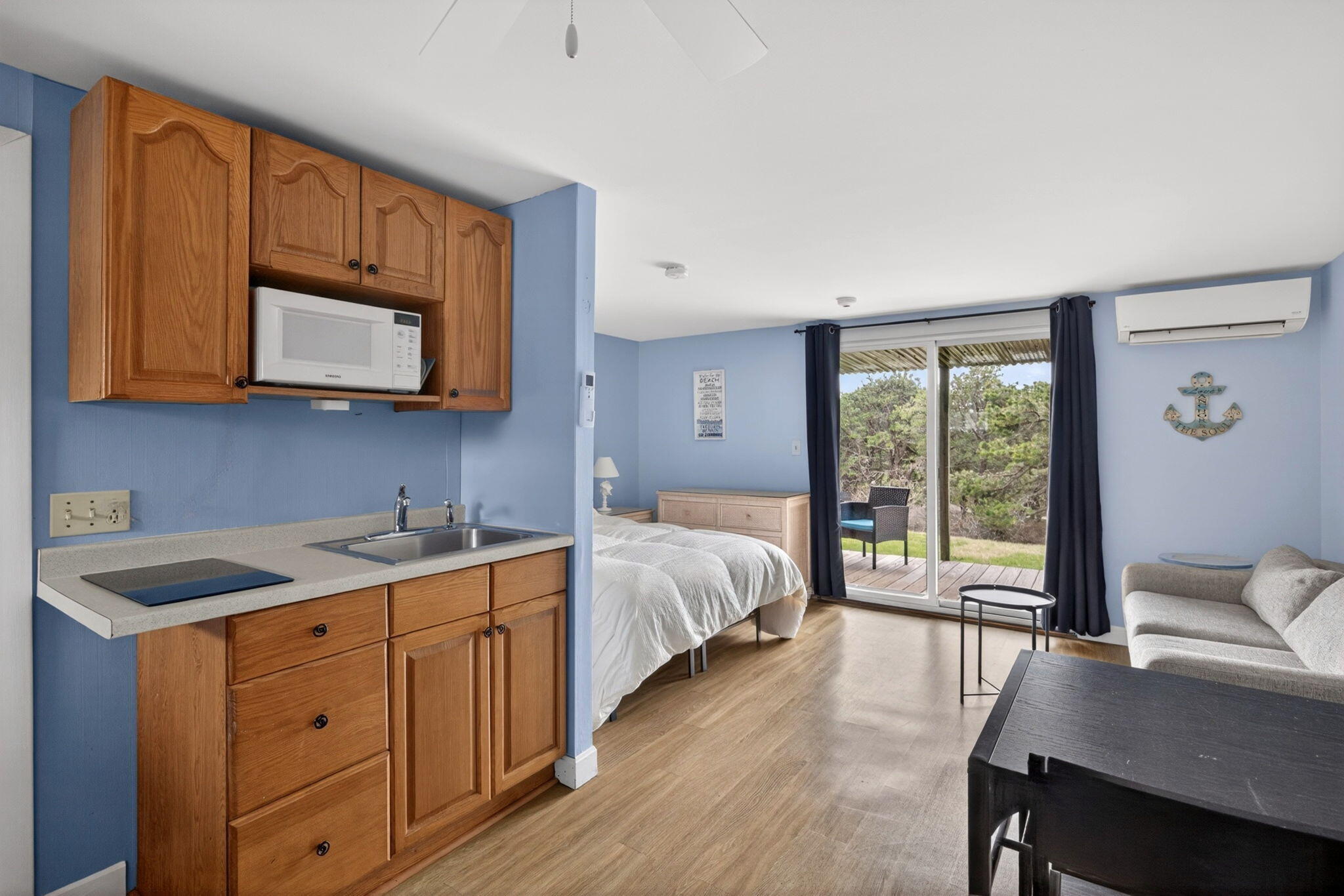 132 Shore Road, Unit 15 Truro, MA 02666 - Photo 8 of 33 a bedroom with a bed and wooden floor