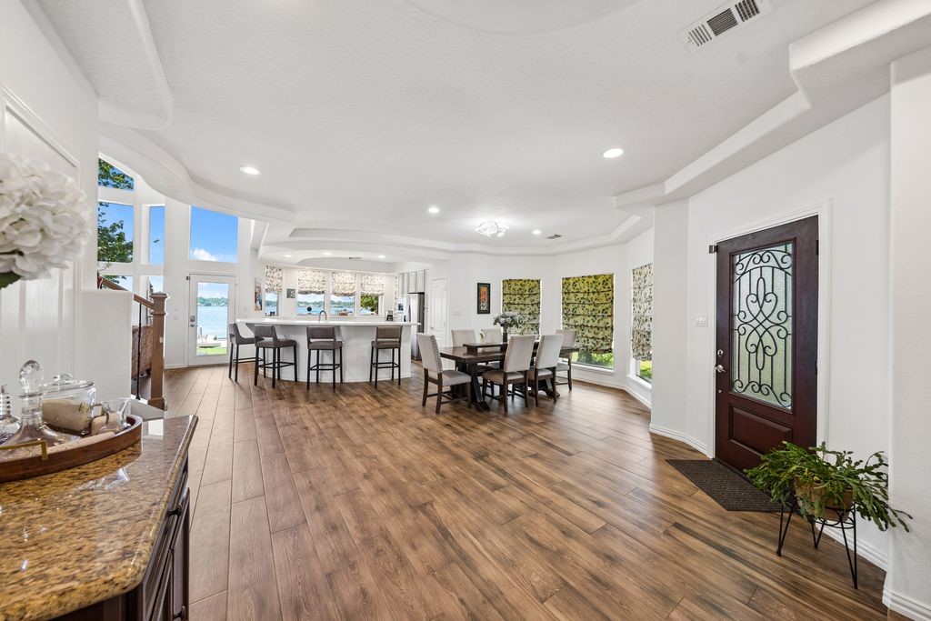 1607 Schooner Point Willis, TX 77318 - Photo 6 of 47 Upon entering the home, you'll notice the grand open area with beautiful plank flooring and immediately seeing the incredible lake view!
