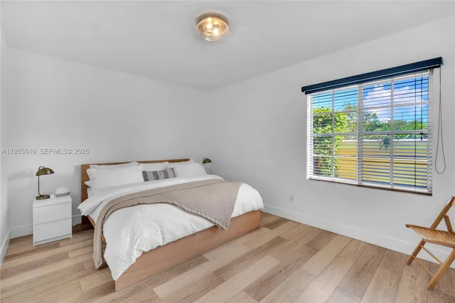 a view of a bedroom with a bed and a window