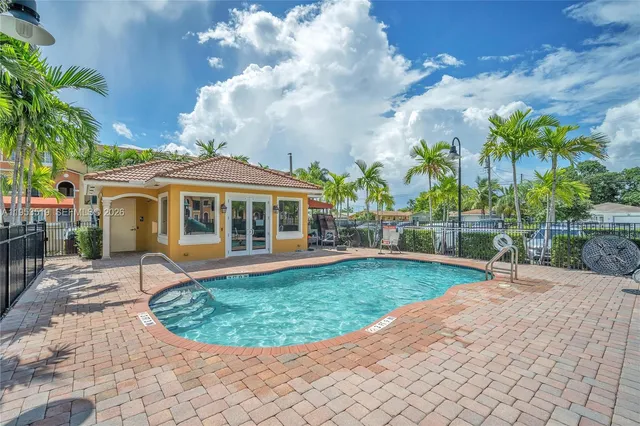 a view of a house with a backyard