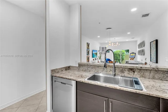 a kitchen with a sink and a refrigerator