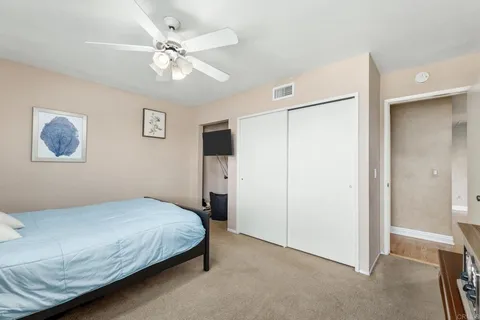 a bedroom with furniture and a large window