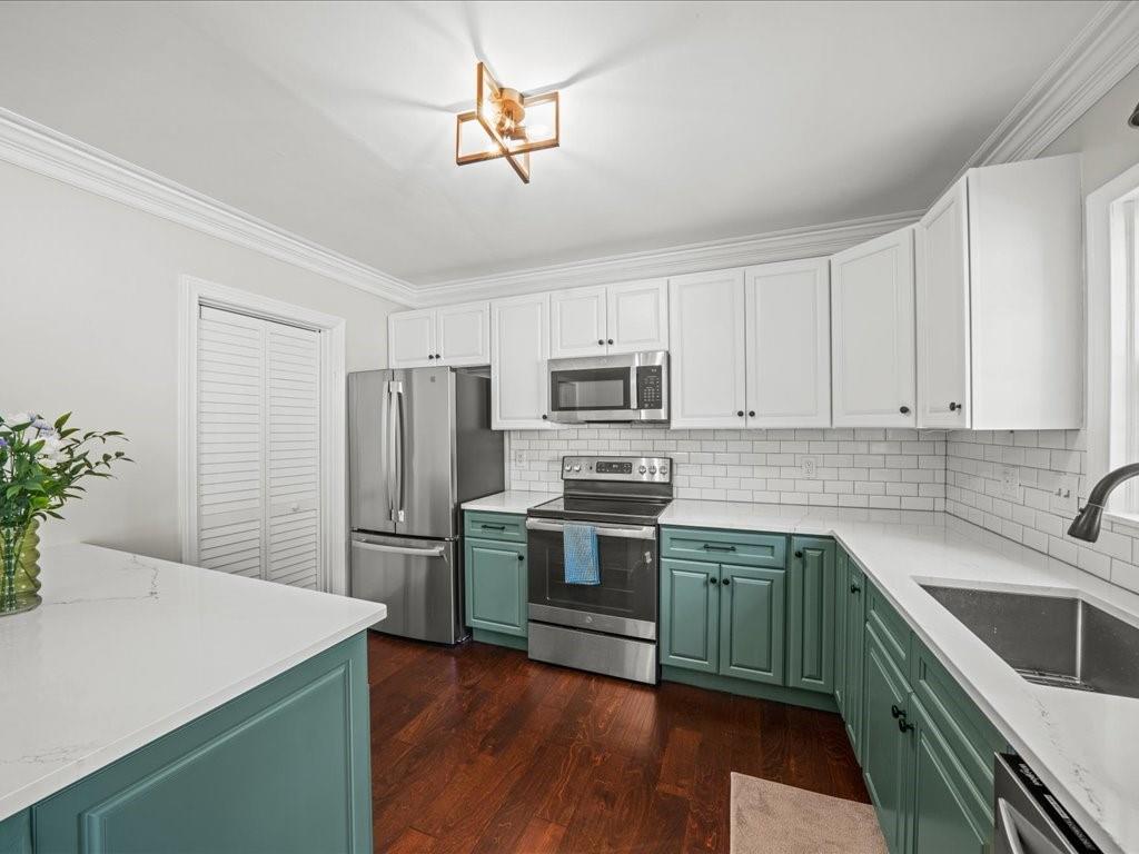 50 Mt Vernon Circle Atlanta, GA 30338 - Photo 11 of 28 a kitchen with stainless steel appliances white cabinets and wooden floors
