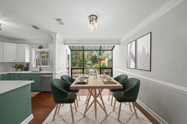 a dining room with furniture a chandelier and wooden floor