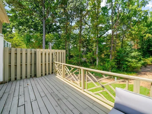 a view of balcony with wooden floor and fence
