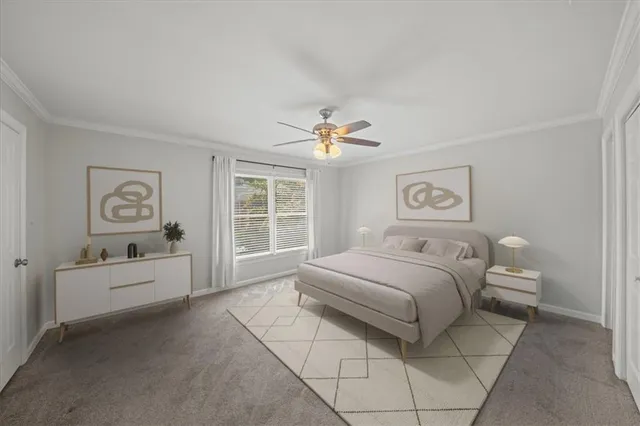 a spacious bedroom with a bed and a chandelier
