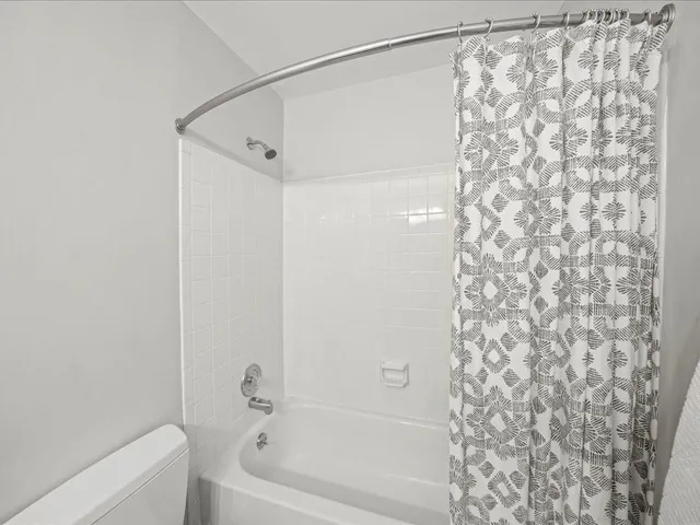 a bathroom with a shower curtain and a shower curtain