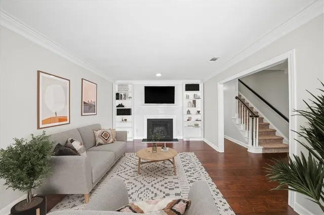 a living room with furniture a fireplace and a flat screen tv