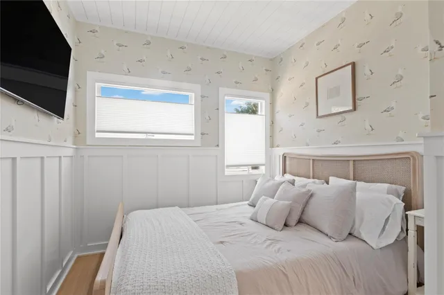 a bedroom with a bed and flat screen tv