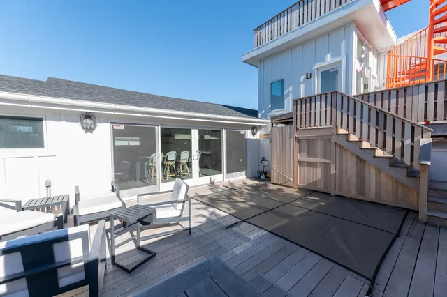 a view of a house with backyard sitting area and wooden floor