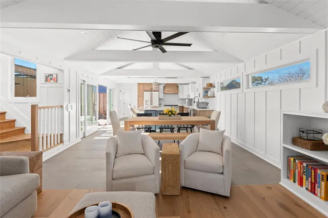 a living room with furniture and a book shelf