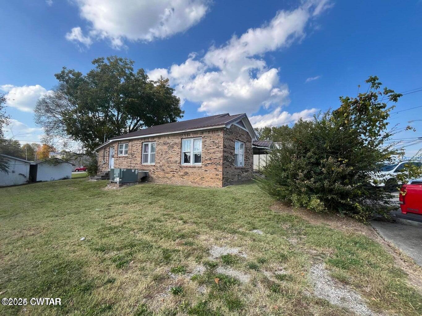 52 South Pleasant Street Decaturville, TN 38329 - Photo 2 of 46 a view of a house with backyard and garden