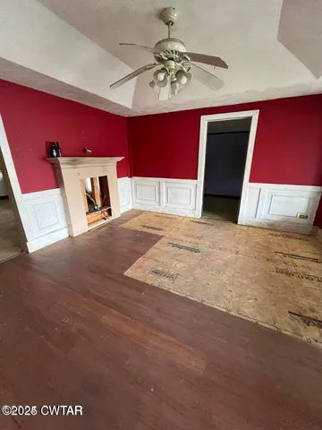a view of a bedroom with a large bed and chandelier