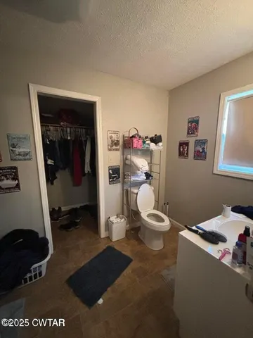 a room with a chair and white walls