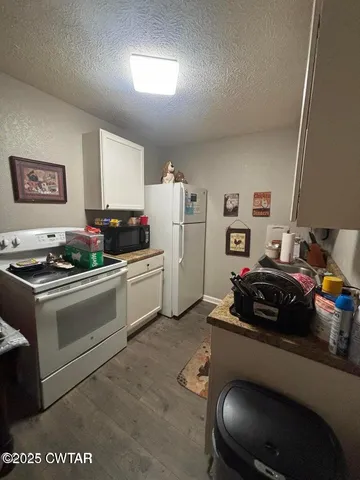 a kitchen with a stove and a refrigerator