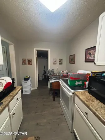 a kitchen filled with a white stove top oven